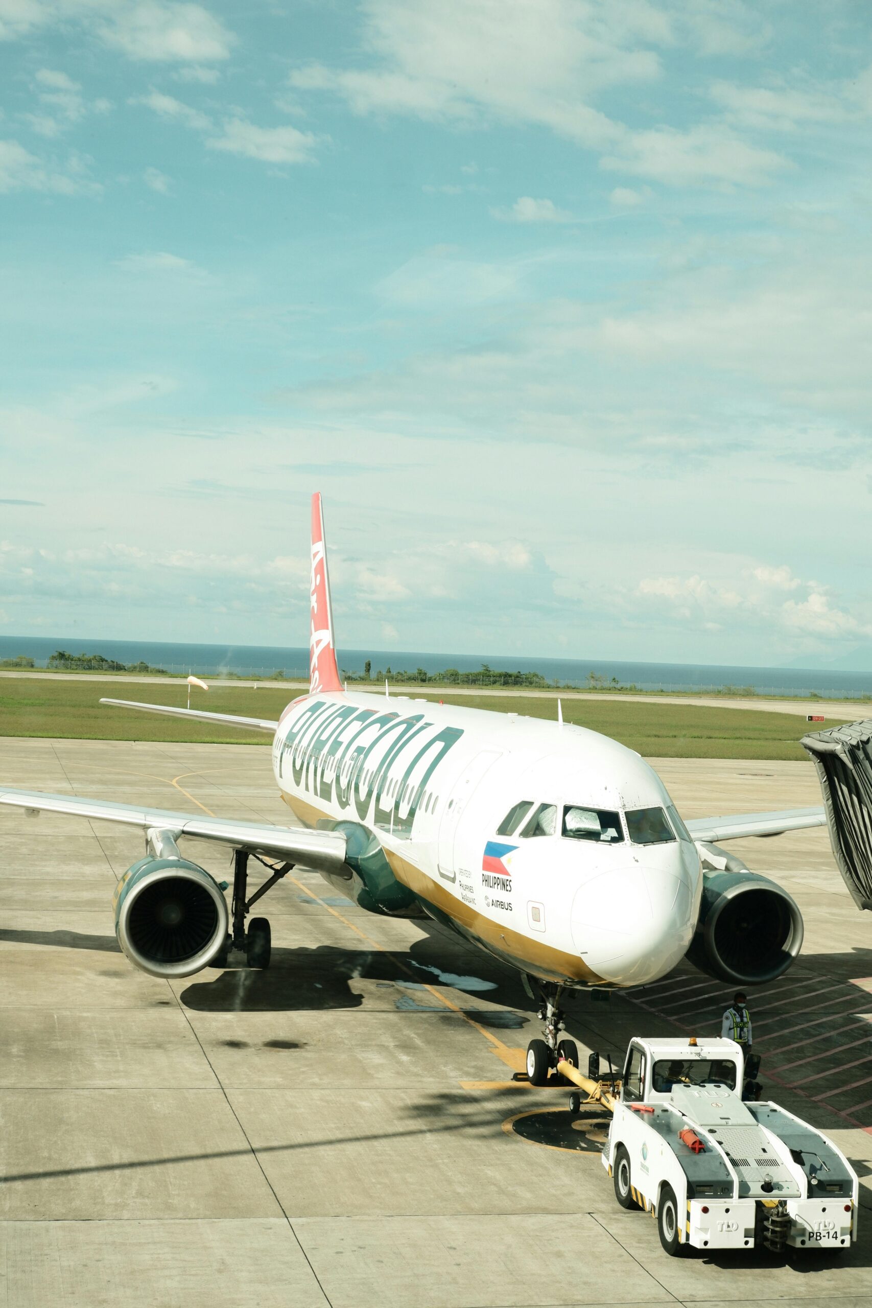 Passenger aircraft at Laguindingan Airport, Philippines, ready for departure on a sunny day.